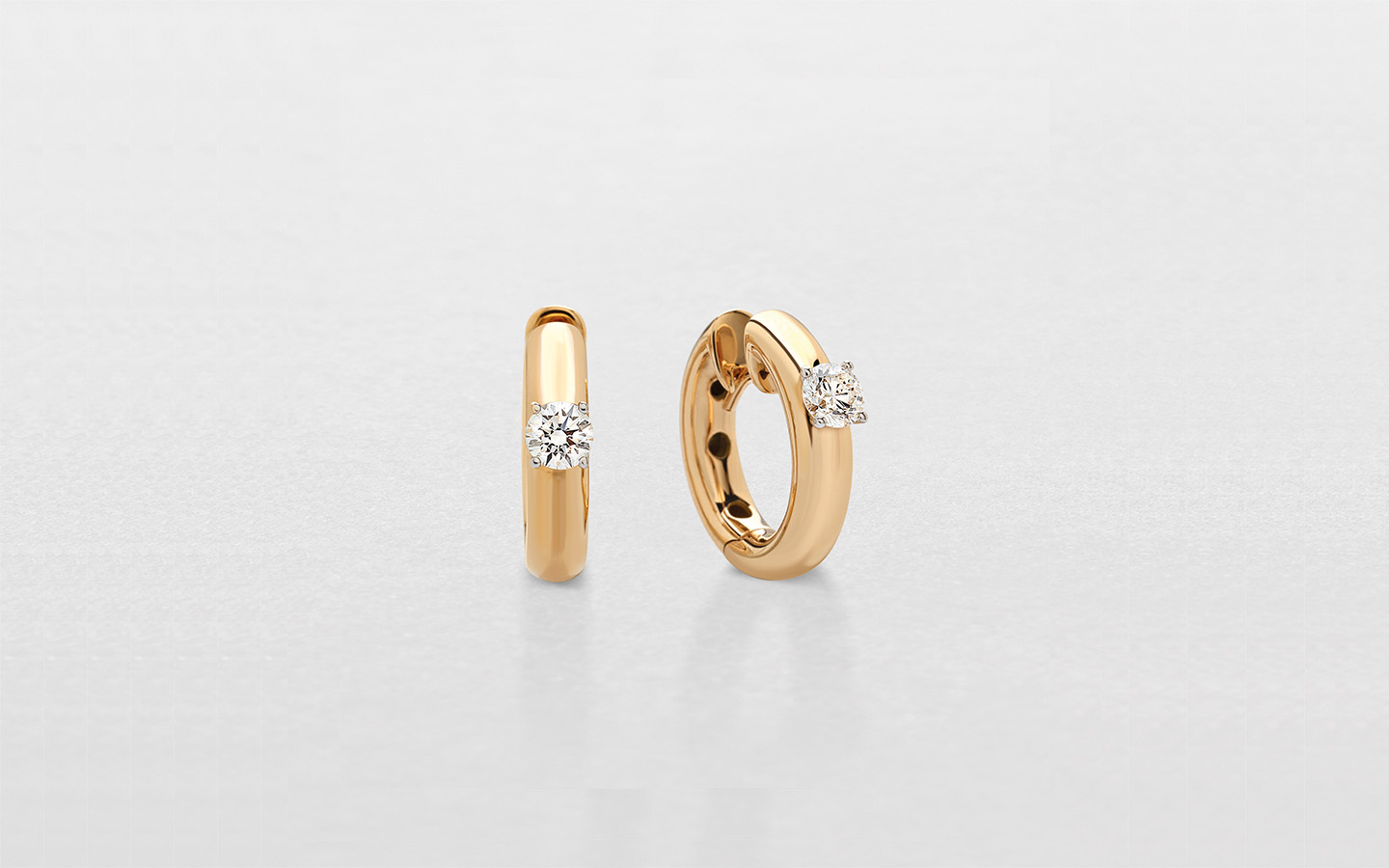 Antologie in oro rosa, con diamante solitario al centro. Orecchini piccoli a cerchio da donna
